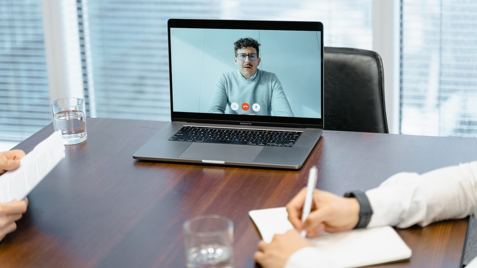 Website designers listening to client speaking about his website and business via video call